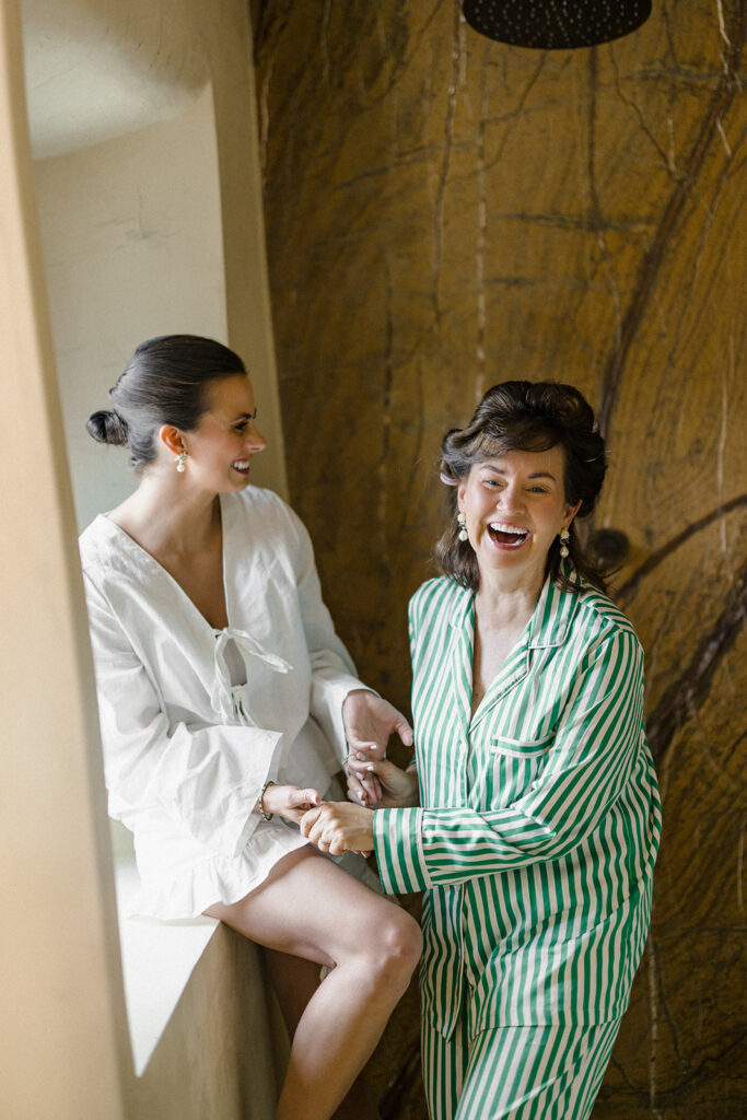 Campbell walking down the aisle during her wedding ceremony at Villa Ardore in Chianti, Tuscany, surrounded by vineyards and close family members in an intimate outdoor Italian wedding setting.