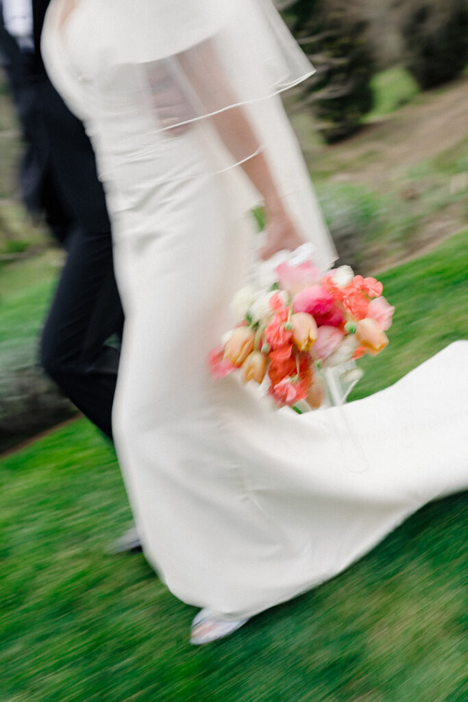 Campbell and Stuart just married at Villa Ardore in Chianti, Tuscany, walking together through the vineyards after their intimate outdoor wedding ceremony in Italy.