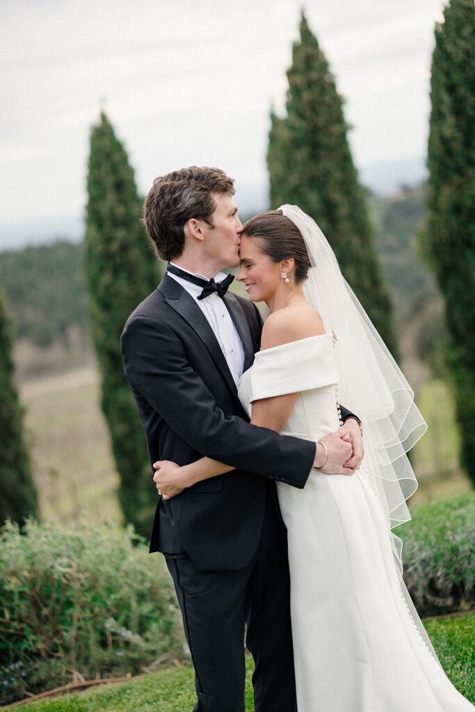 Campbell and Stuart just married at Villa Ardore in Chianti, Tuscany, walking together through the vineyards after their intimate outdoor wedding ceremony in Italy.