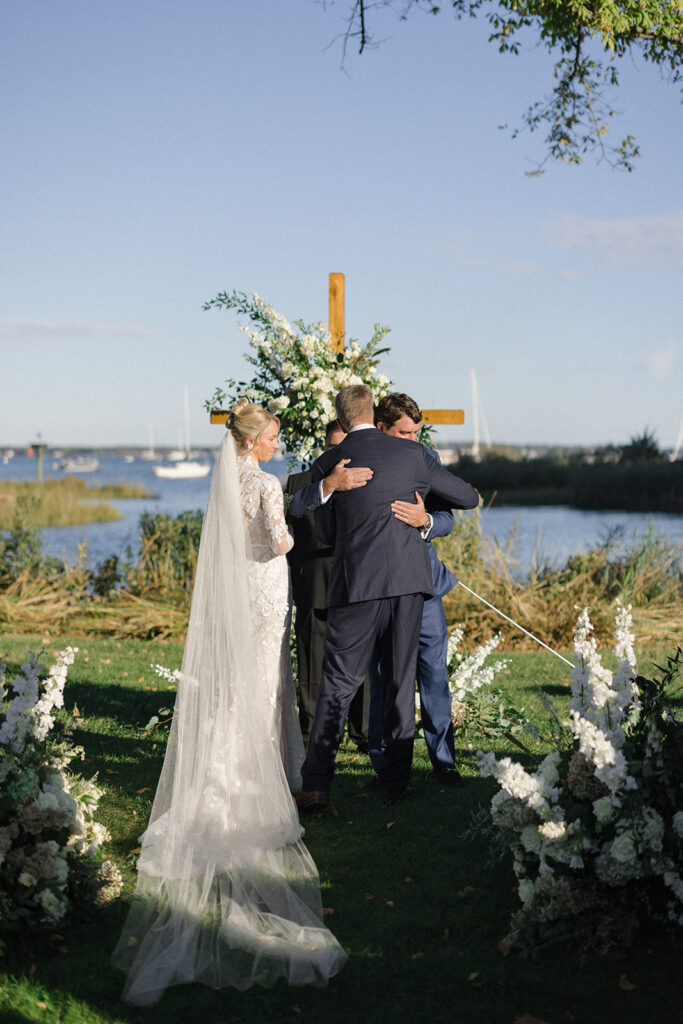 Catherine and Taylor’s fall wedding ceremony at the Inn at Perry Cabin in St. Michaels Maryland overlooking the Chesapeake Bay