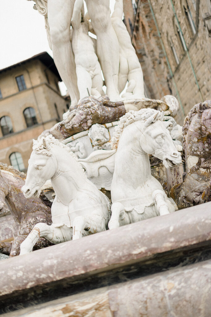 Campbell and Stuart during their engagement session in Florence, Italy, walking through historic cobblestone streets surrounded by classic Renaissance architecture at golden hour before their Tuscany wedding celebration.