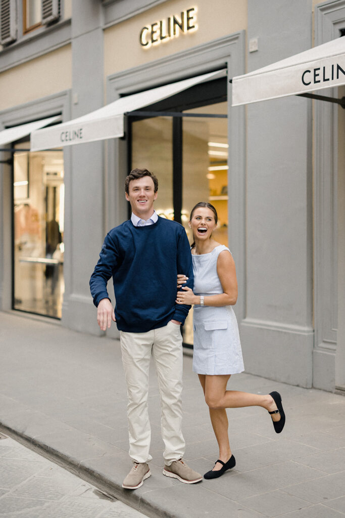 Campbell and Stuart during their engagement session in Florence, Italy, walking through historic cobblestone streets surrounded by classic Renaissance architecture at golden hour before their Tuscany wedding celebration.
