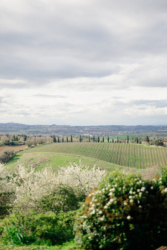 Campbell and Stuart participating in a hands-on cooking class in Italy, surrounded by family and shared laughter.