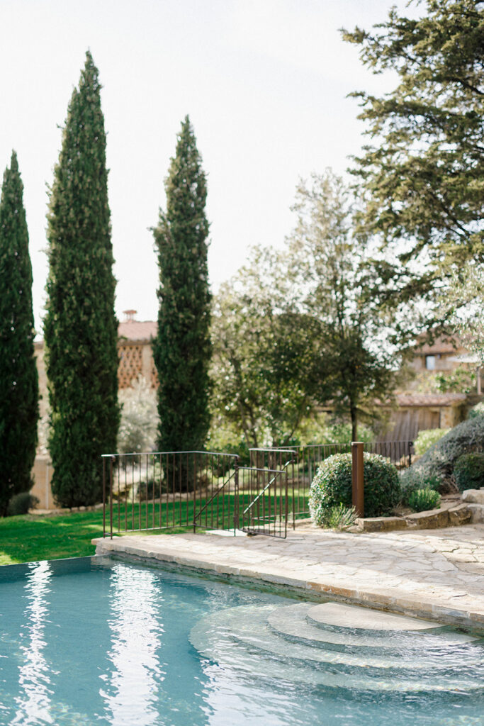 Campbell walking down the aisle during her wedding ceremony at Villa Ardore in Chianti, Tuscany, surrounded by vineyards and close family members in an intimate outdoor Italian wedding setting.