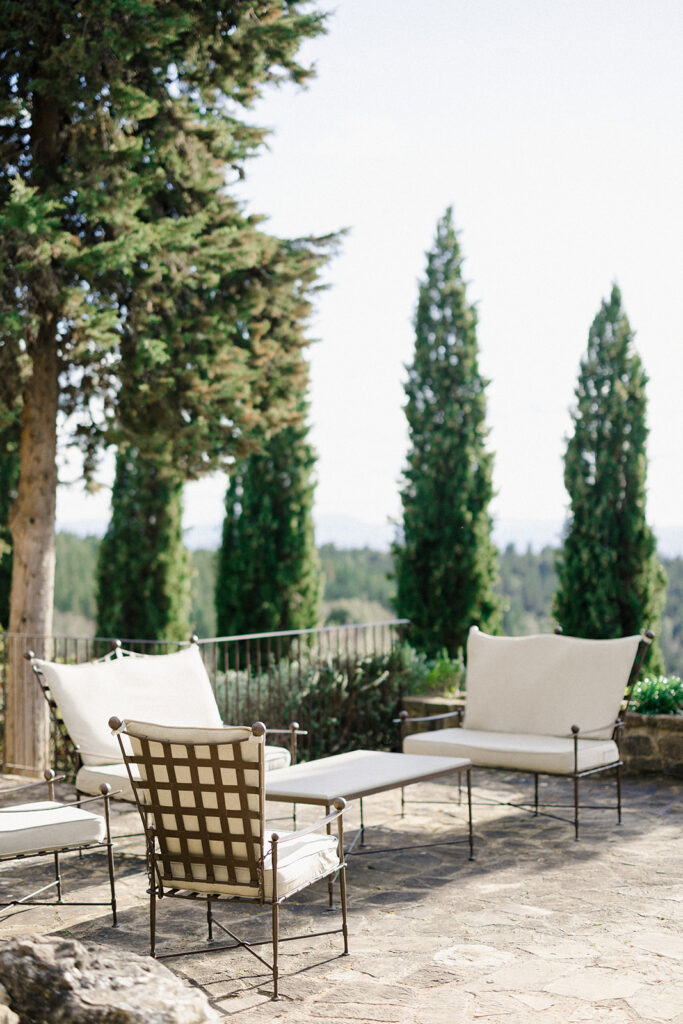 Campbell walking down the aisle during her wedding ceremony at Villa Ardore in Chianti, Tuscany, surrounded by vineyards and close family members in an intimate outdoor Italian wedding setting.