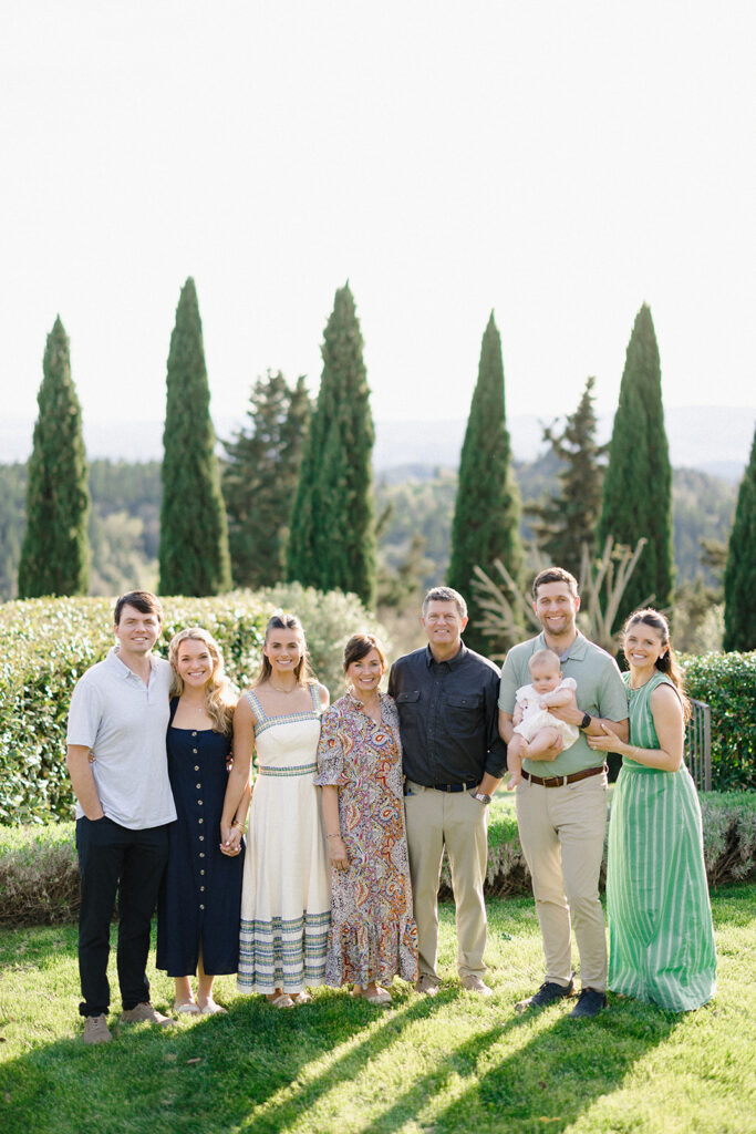 Campbell and Stuart participating in a hands-on cooking class in Italy, surrounded by family and shared laughter.