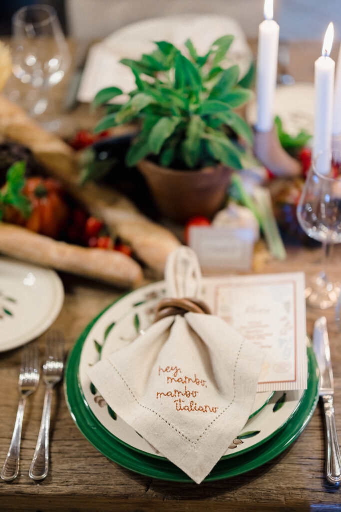 Campbell and Stuart participating in a hands-on cooking class in Italy, surrounded by family and shared laughter.