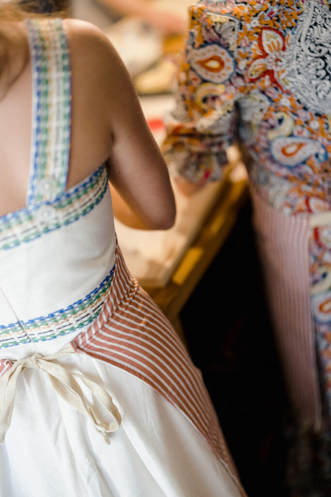 Campbell and Stuart participating in a hands-on cooking class in Italy, surrounded by family and shared laughter.