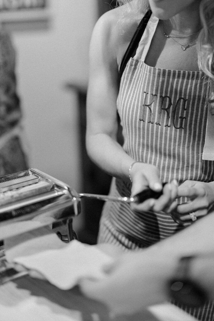 Campbell and Stuart participating in a hands-on cooking class in Italy, surrounded by family and shared laughter.