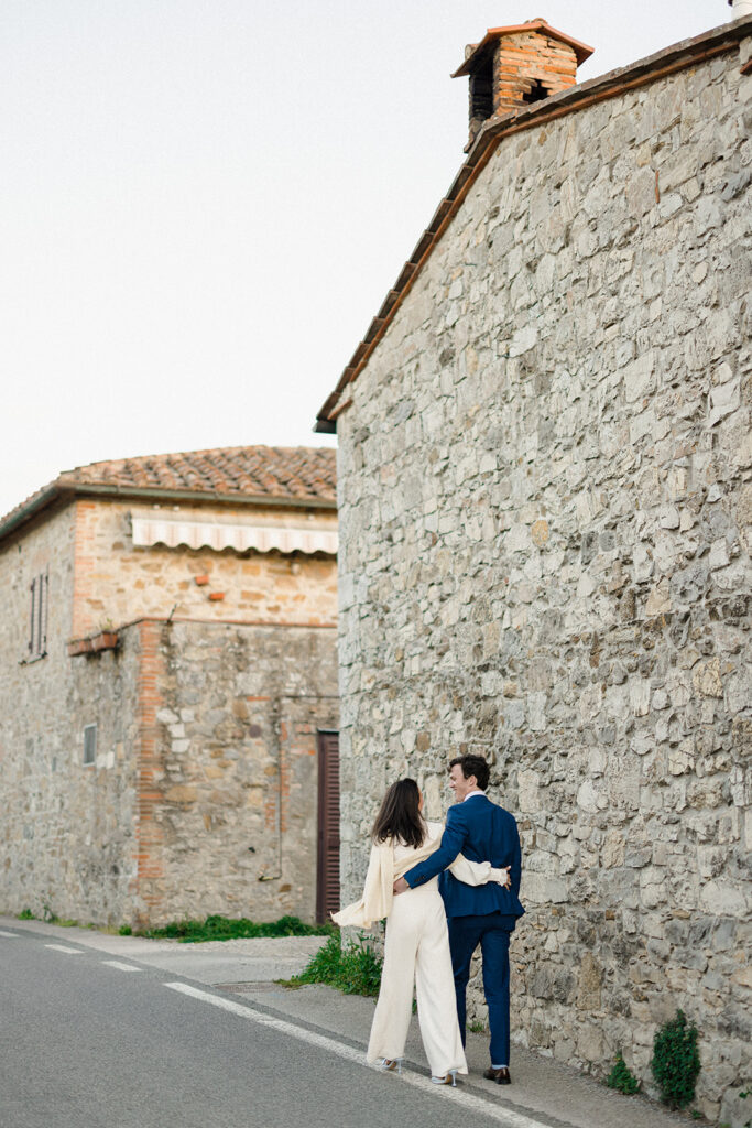 Intimate rehearsal dinner in Italy with candlelit tables, close family, and an outdoor evening setting.