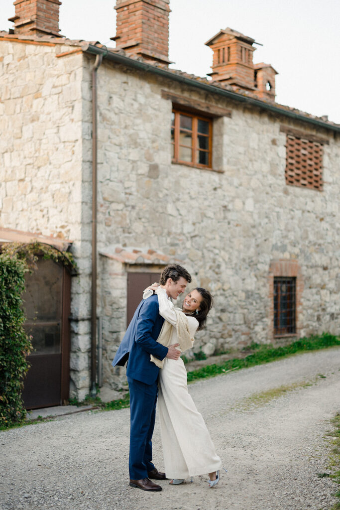 Intimate rehearsal dinner in Italy with candlelit tables, close family, and an outdoor evening setting.