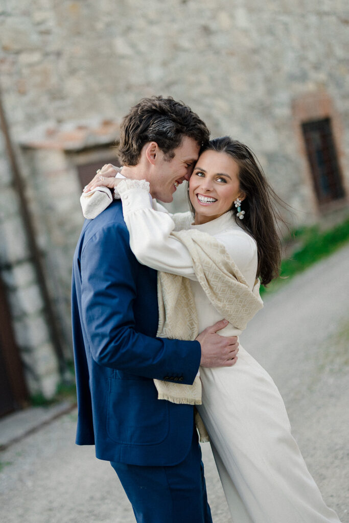 Intimate rehearsal dinner in Italy with candlelit tables, close family, and an outdoor evening setting.