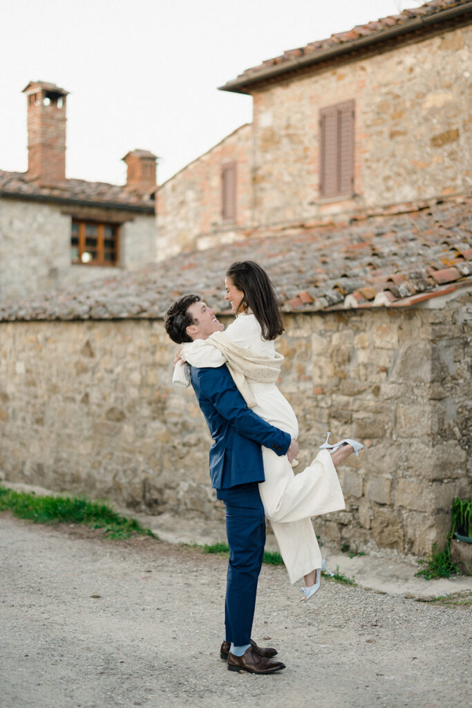 Intimate rehearsal dinner in Italy with candlelit tables, close family, and an outdoor evening setting.