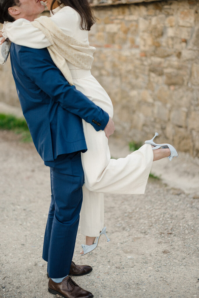Intimate rehearsal dinner in Italy with candlelit tables, close family, and an outdoor evening setting.