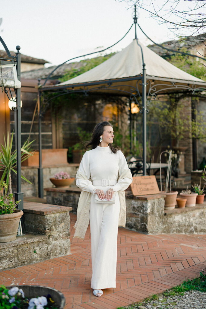Intimate rehearsal dinner in Italy with candlelit tables, close family, and an outdoor evening setting.