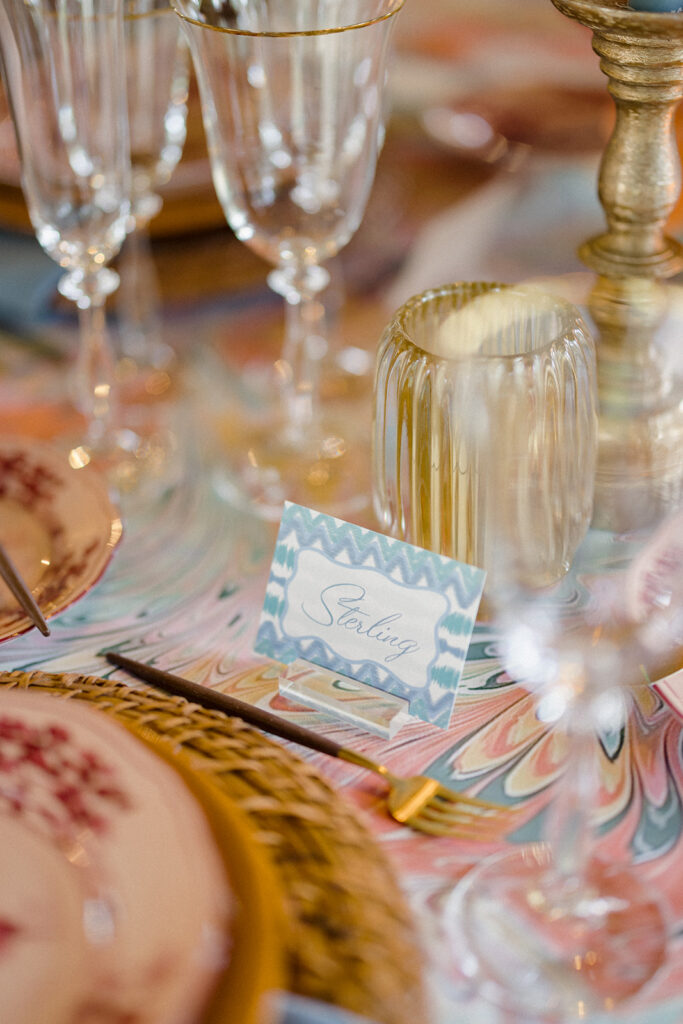 Candlelit wedding reception dinner at Villa Ardore in Chianti, Tuscany, with long tables, vibrant florals by Tuscany Flowers, and family gathered together overlooking the Tuscan hills at sunset.