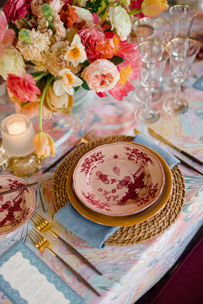 Candlelit wedding reception dinner at Villa Ardore in Chianti, Tuscany, with long tables, vibrant florals by Tuscany Flowers, and family gathered together overlooking the Tuscan hills at sunset.