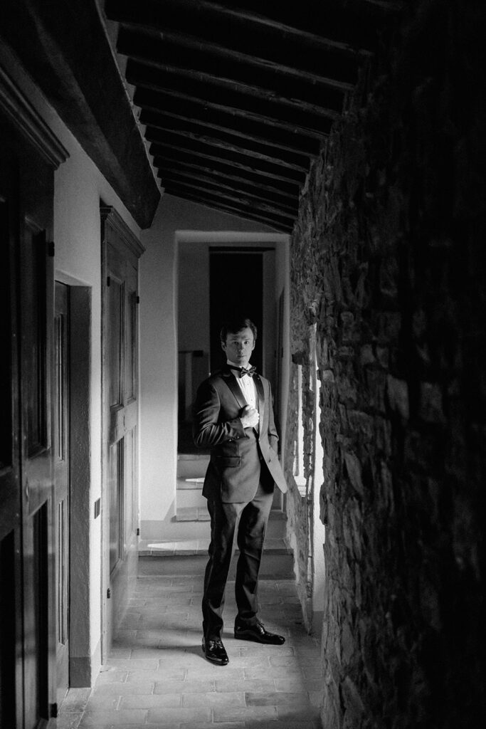 Stuart getting ready for his wedding at Villa Ardore in Chianti, Tuscany, adjusting his suit inside the Italian villa before the outdoor ceremony.