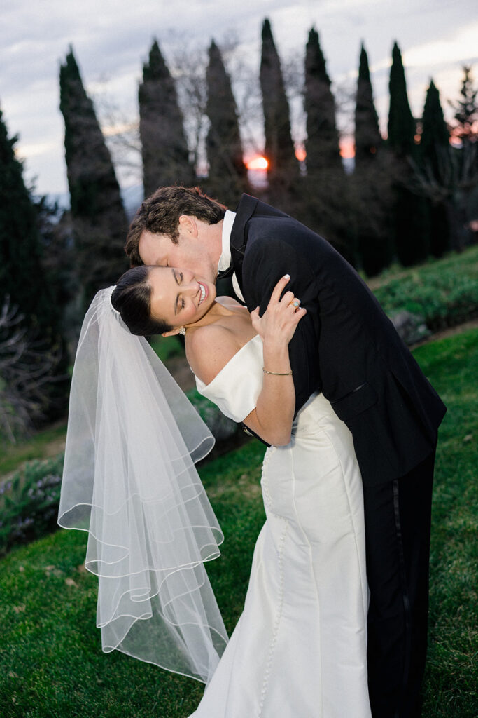 Campbell and Stuart just married at Villa Ardore in Chianti, Tuscany, walking together through the vineyards after their intimate outdoor wedding ceremony in Italy.