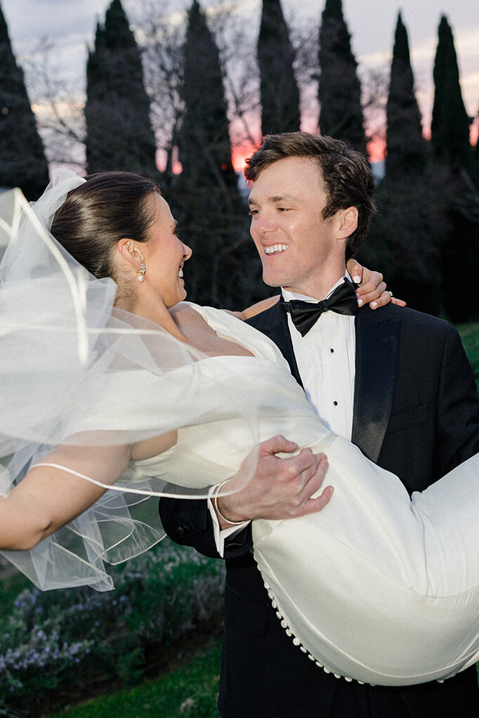Campbell and Stuart just married at Villa Ardore in Chianti, Tuscany, walking together through the vineyards after their intimate outdoor wedding ceremony in Italy.