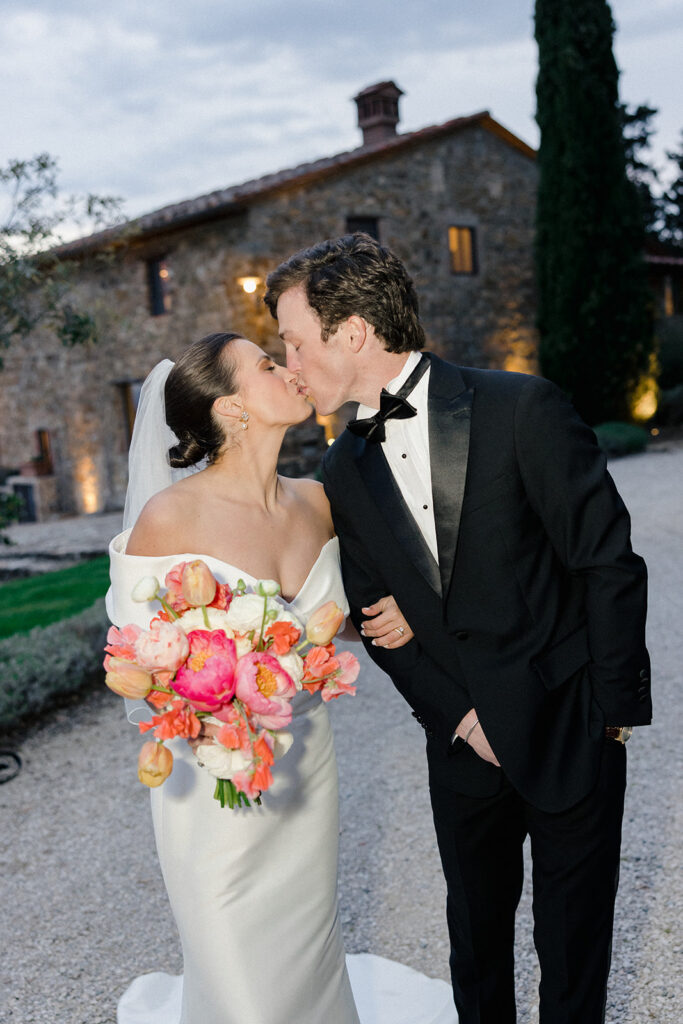 Campbell and Stuart just married at Villa Ardore in Chianti, Tuscany, walking together through the vineyards after their intimate outdoor wedding ceremony in Italy.