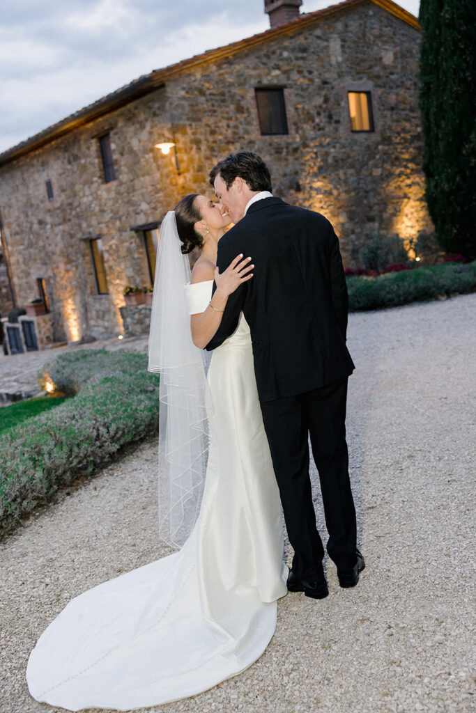 Campbell and Stuart just married at Villa Ardore in Chianti, Tuscany, walking together through the vineyards after their intimate outdoor wedding ceremony in Italy.
