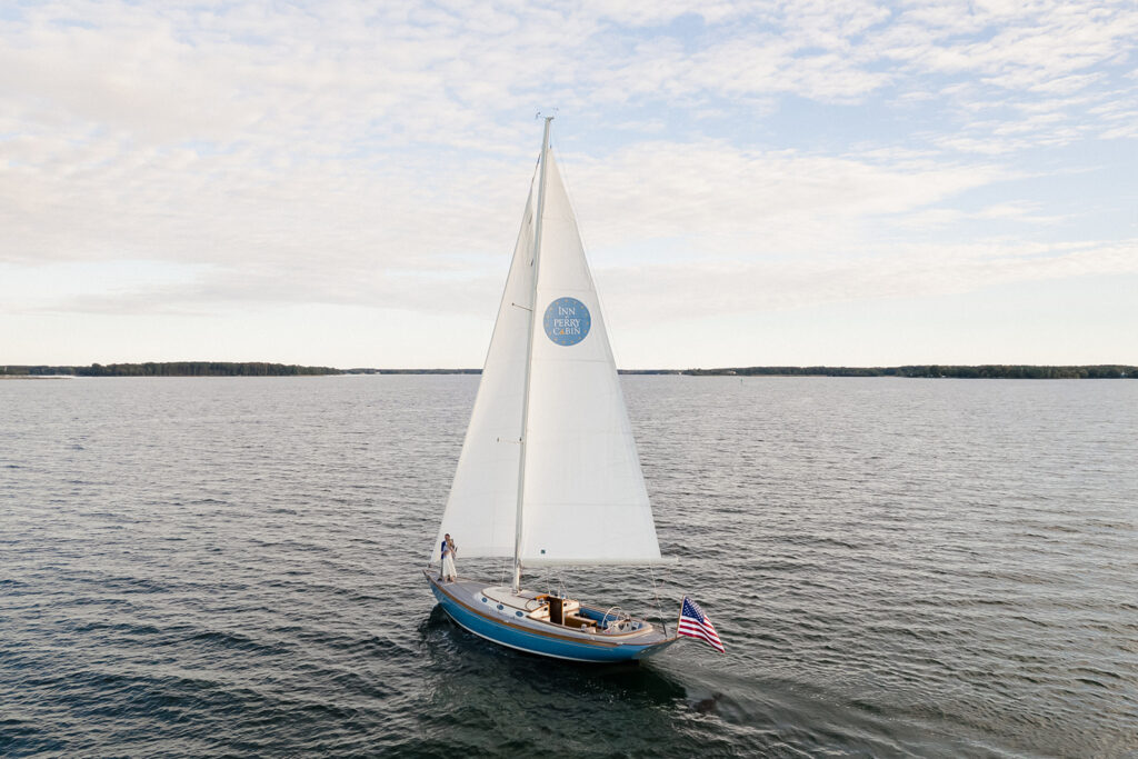 Chesapeake Bay engagement session with Catherine and Taylor sailing during their Maryland waterfront engagement photos