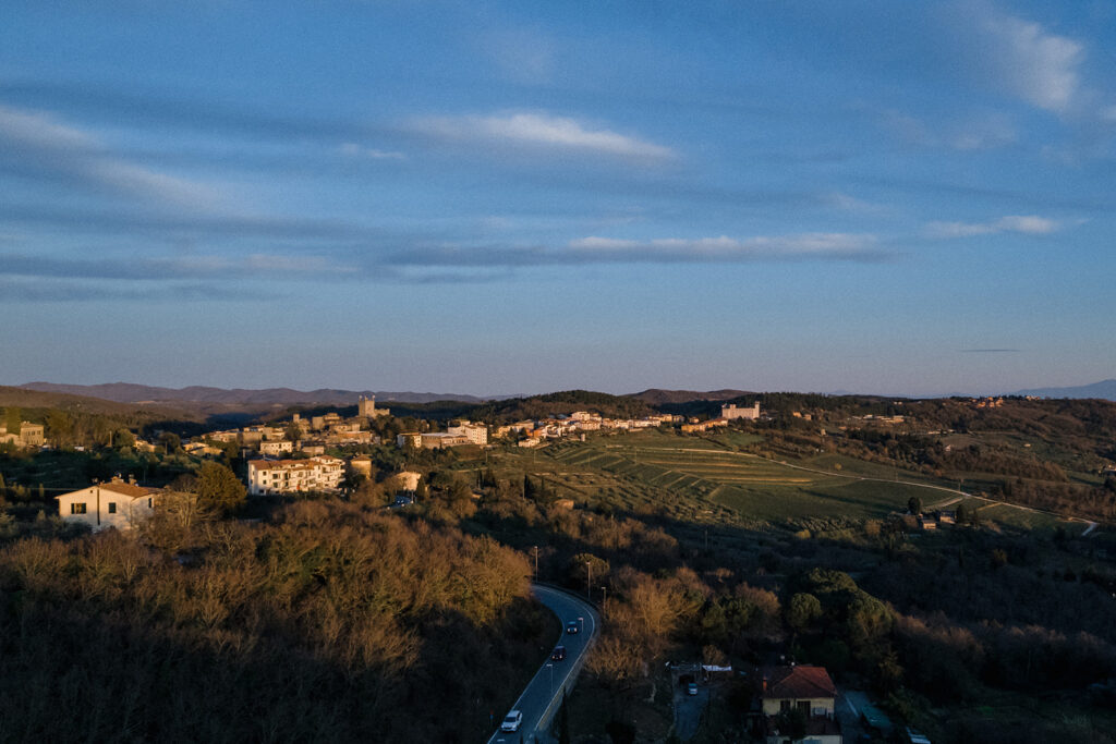 Intimate rehearsal dinner in Italy with candlelit tables, close family, and an outdoor evening setting.